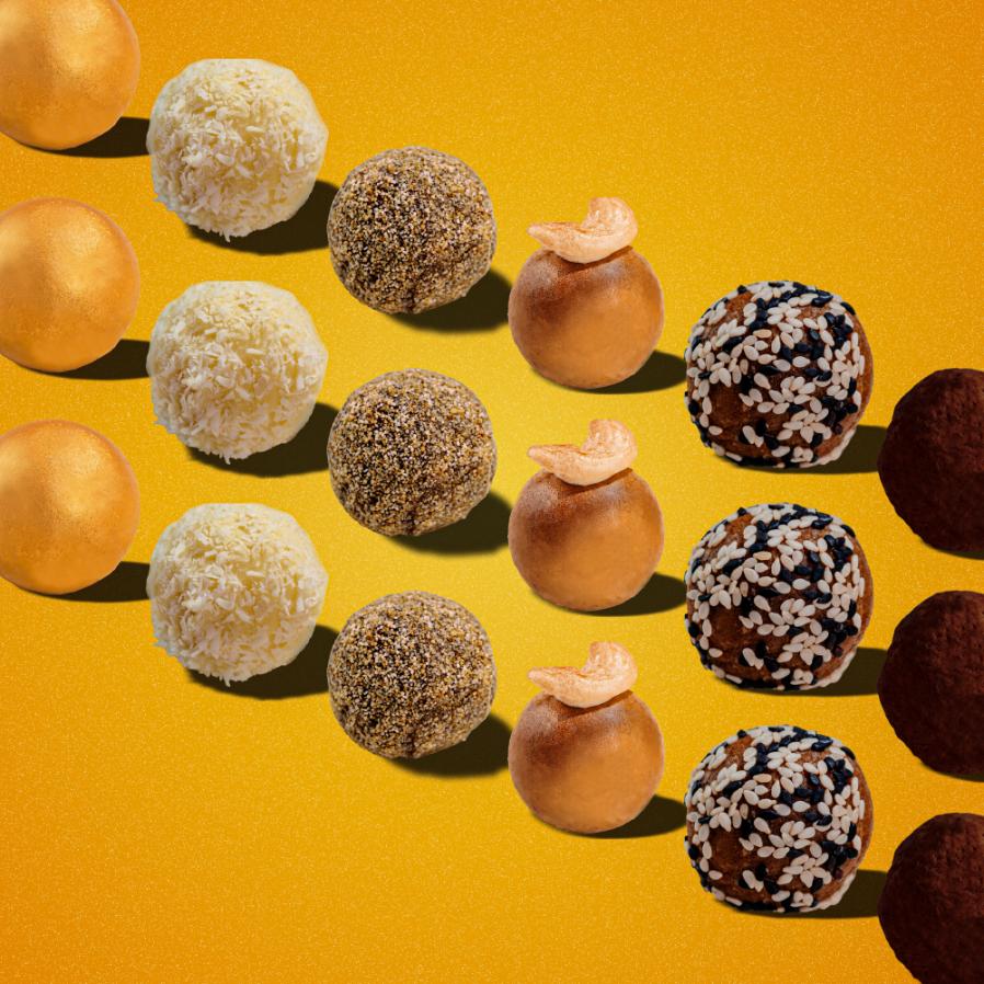 Assorted nut-free Indian ladoos arranged in rows on vibrant yellow background, showcasing variety of flavors and textures including coconut, chocolate, and besan, perfect for those with dietary restrictions or allergies.