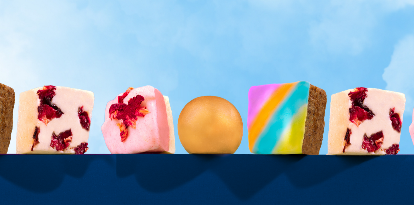 Assorted colorful indian mithai sweets on a blue surface with a blue sky background